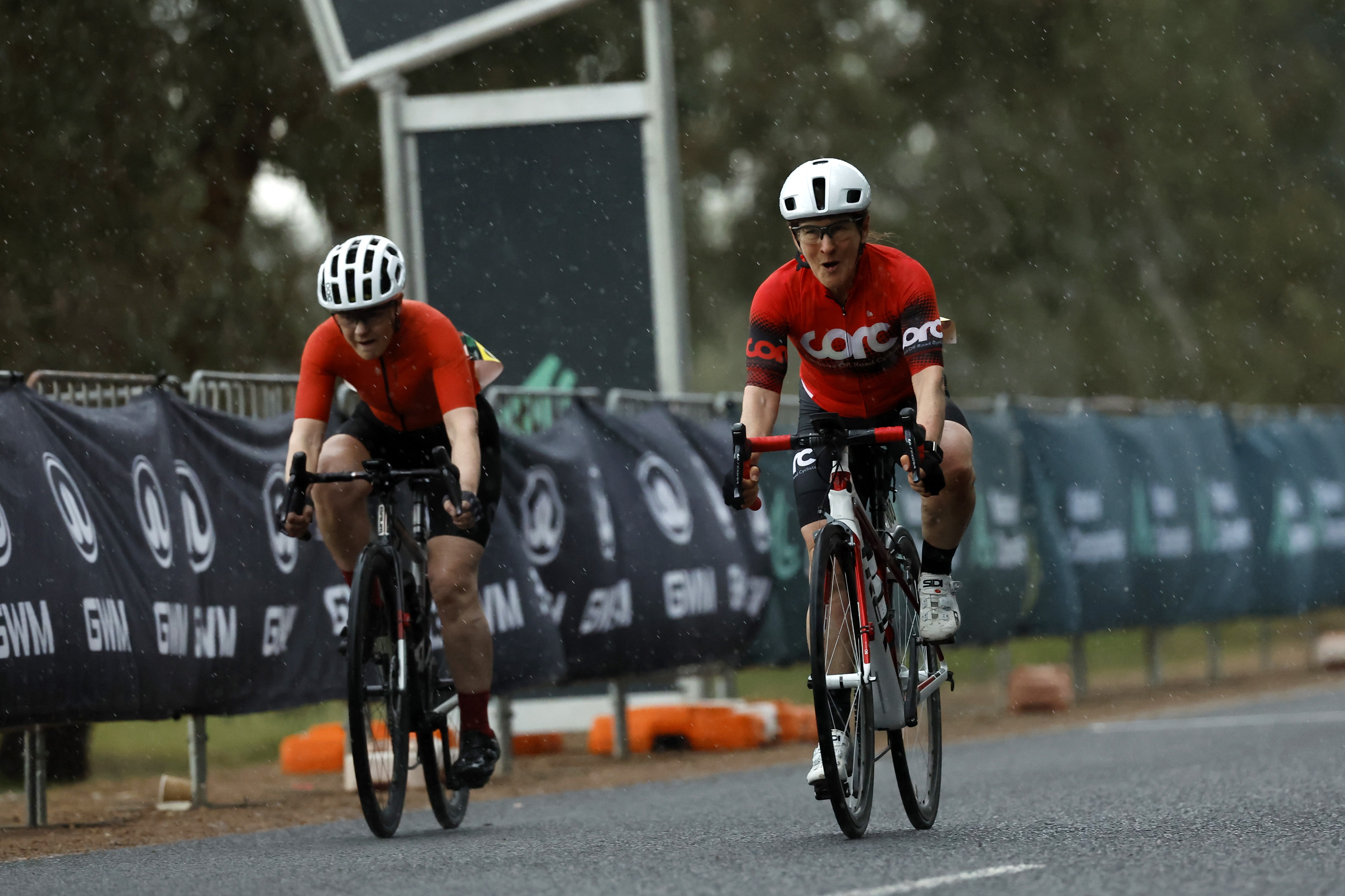 Two riders finish in the rain during the women's masters road race at the 2025 AusCycling Junior and Masters Road National Championships